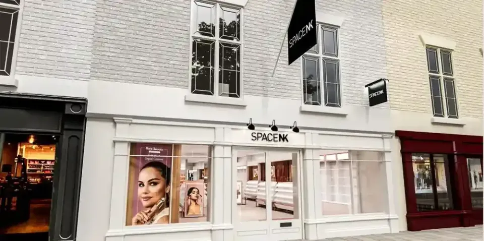 The new Space NK store at St Martins Yard, Coney Street, York — a white-rendered shopfront with the Space NK fascia, hanging sign and window graphics, set within the restored parade of buildings